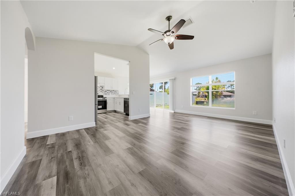 4621 25th Street Southwest Lehigh Acres, FL 33973 - Photo 12 of 41 wooden floor in an empty room with a window