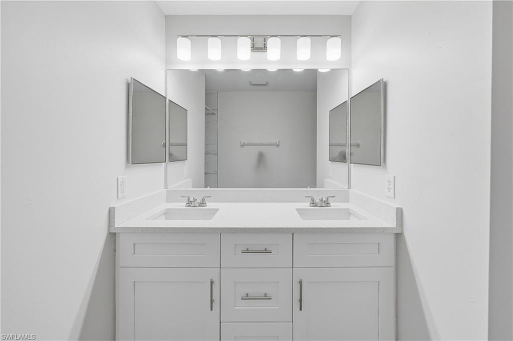 4621 25th Street Southwest Lehigh Acres, FL 33973 - Photo 15 of 41 a bathroom with a sink and a mirror