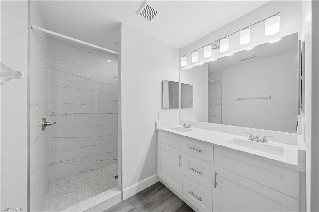 4621 25th Street Southwest Lehigh Acres, FL 33973 - Photo 16 of 41 a bathroom with a shower sink and mirror