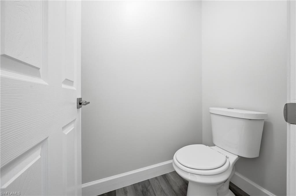 4621 25th Street Southwest Lehigh Acres, FL 33973 - Photo 17 of 41 a white toilet sitting next to a shower