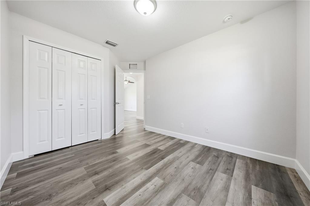 4621 25th Street Southwest Lehigh Acres, FL 33973 - Photo 20 of 41 a view of an empty room with wooden floor