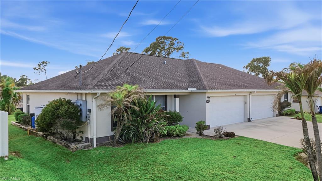4621 25th Street Southwest Lehigh Acres, FL 33973 - Photo 2 of 41 a front view of house with a garden