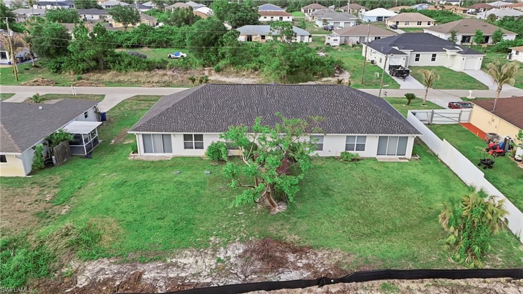 4621 25th Street Southwest Lehigh Acres, FL 33973 - Photo 31 of 41 a aerial view of a house with a yard