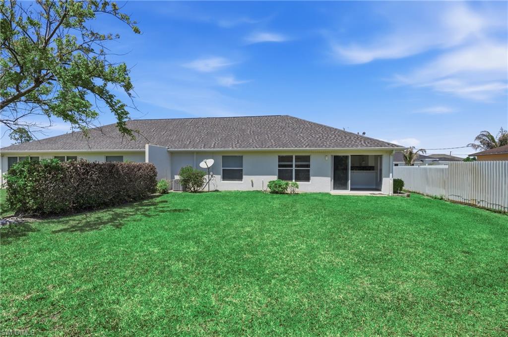 4621 25th Street Southwest Lehigh Acres, FL 33973 - Photo 32 of 41 a front view of a house with a yard