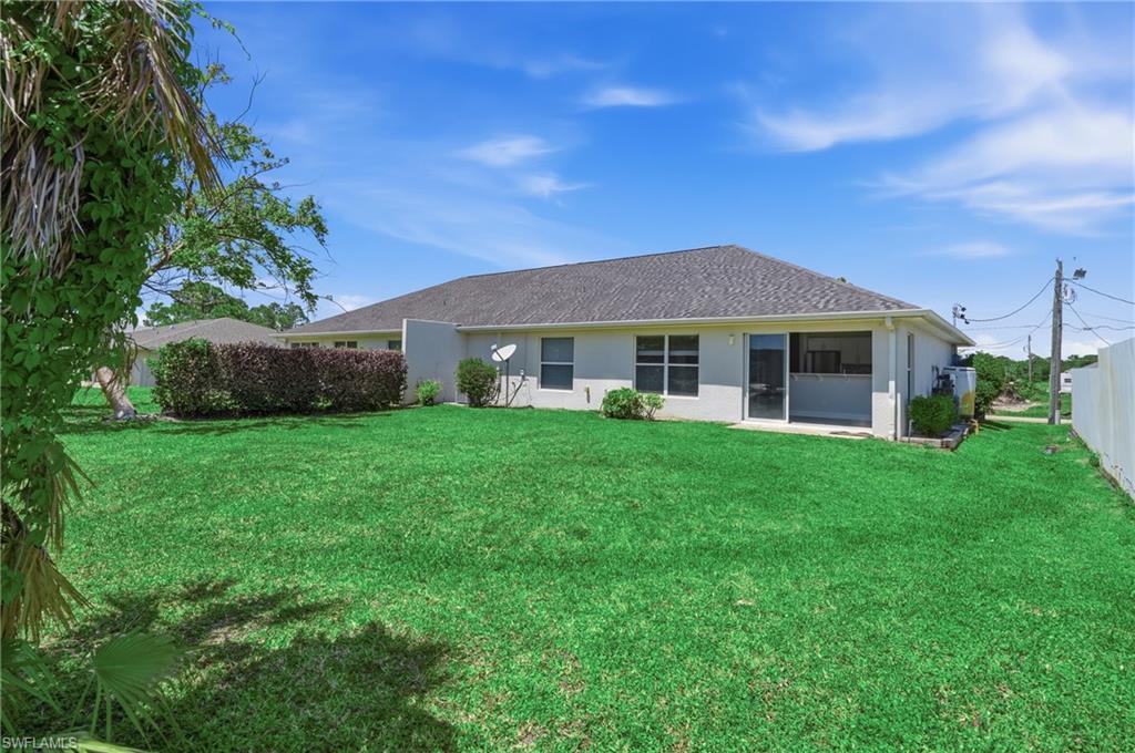 4621 25th Street Southwest Lehigh Acres, FL 33973 - Photo 33 of 41 a front view of a house with a garden