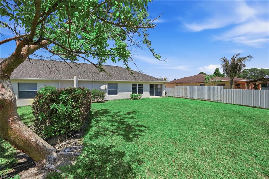 4621 25th Street Southwest Lehigh Acres, FL 33973 - Photo 34 of 41 a front view of a house with a yard