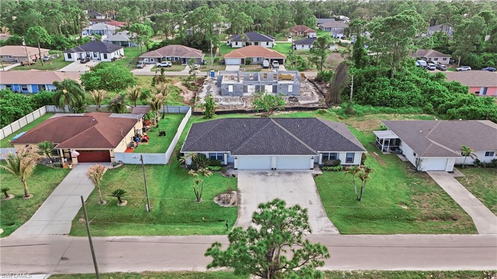 4621 25th Street Southwest Lehigh Acres, FL 33973 - Photo 37 of 41 an aerial view of multiple houses with yard