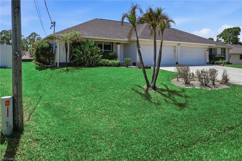 4621 25th Street Southwest Lehigh Acres, FL 33973 - Photo 38 of 41 a front view of a house with garden