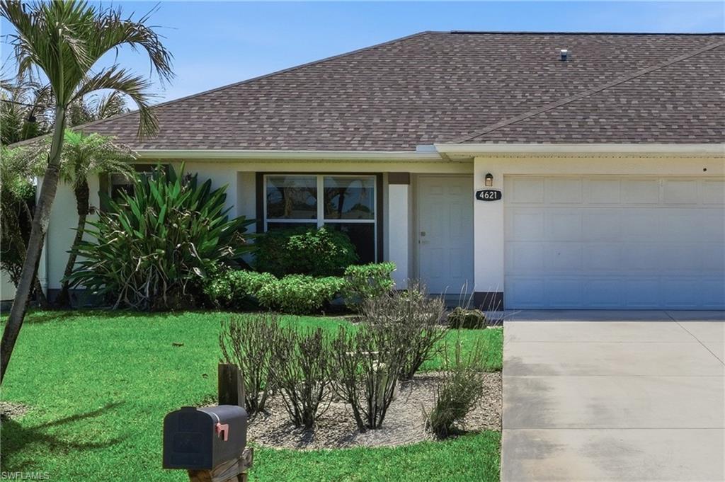 4621 25th Street Southwest Lehigh Acres, FL 33973 - Photo 39 of 41 a front view of a house with garden