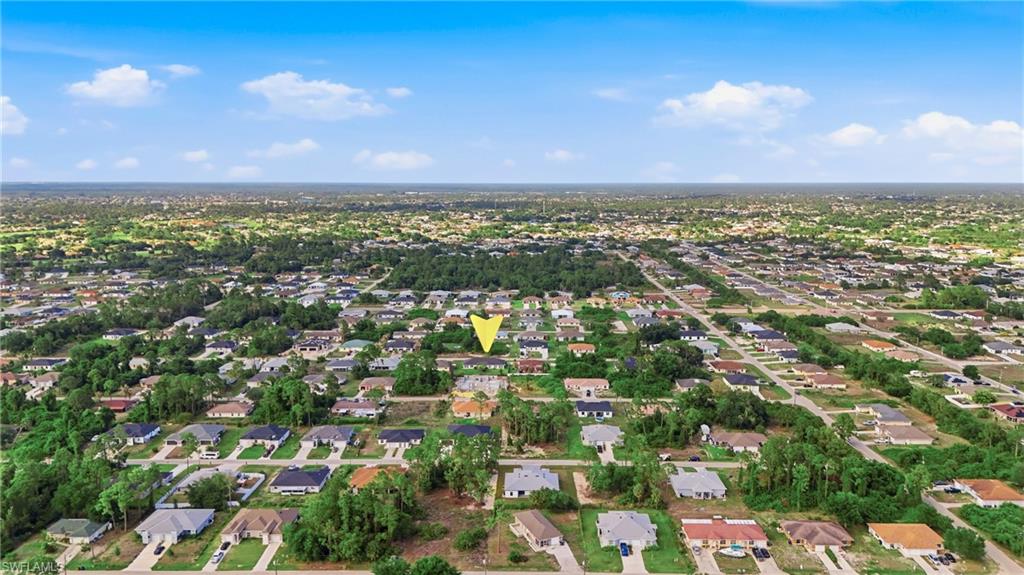 4621 25th Street Southwest Lehigh Acres, FL 33973 - Photo 41 of 41 an aerial view of residential houses with outdoor space and trees