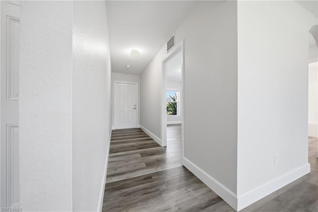 4621 25th Street Southwest Lehigh Acres, FL 33973 - Photo 7 of 41 a view of a hallway with wooden floor and entryway