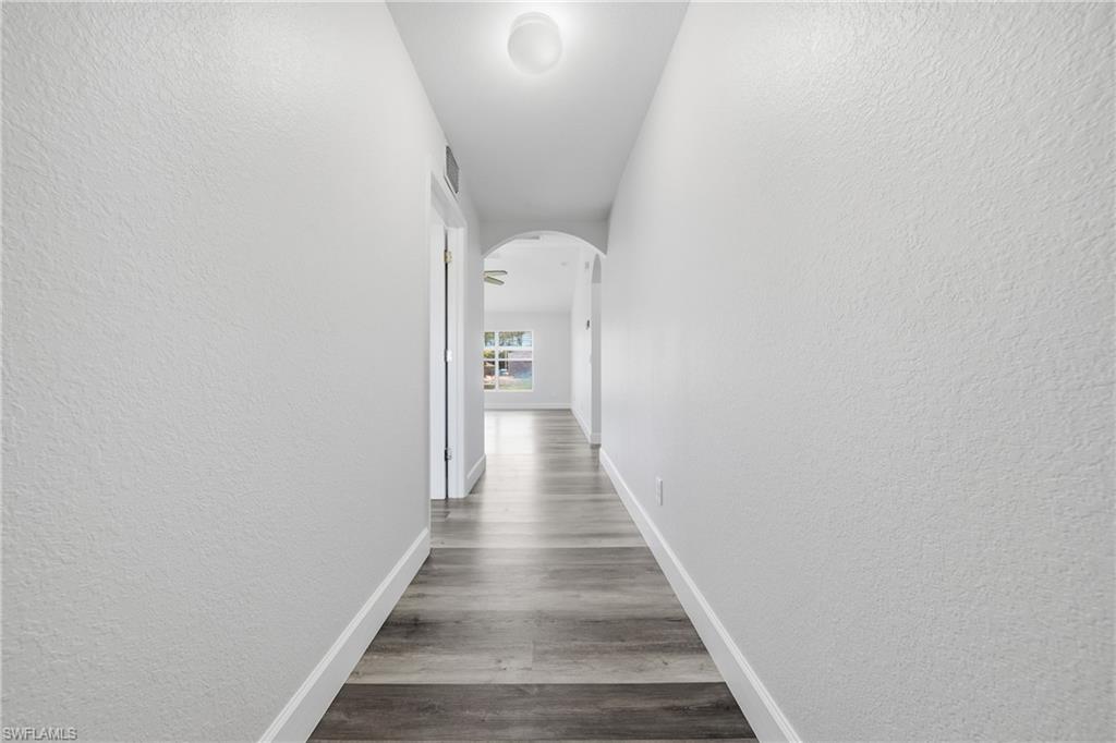4621 25th Street Southwest Lehigh Acres, FL 33973 - Photo 10 of 41 a view of a hallway with wooden floor