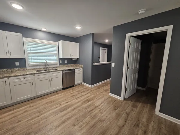a kitchen with stainless steel appliances granite countertop a refrigerator sink and cabinets