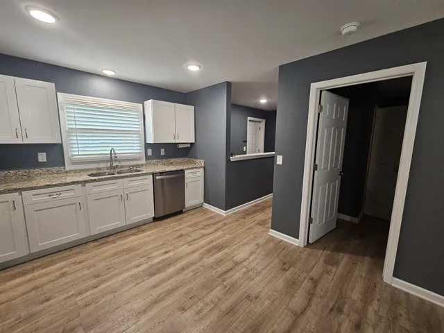 a kitchen with stainless steel appliances granite countertop a refrigerator sink and cabinets