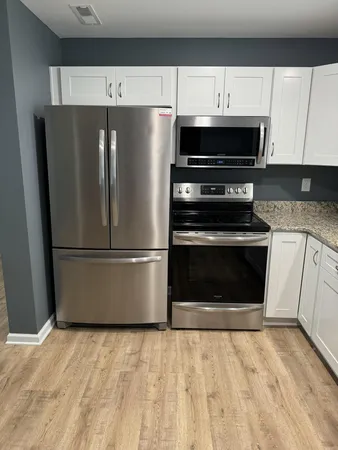 a kitchen with a refrigerator and a stove