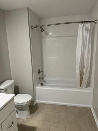 a bathroom with a toilet and a bathtub