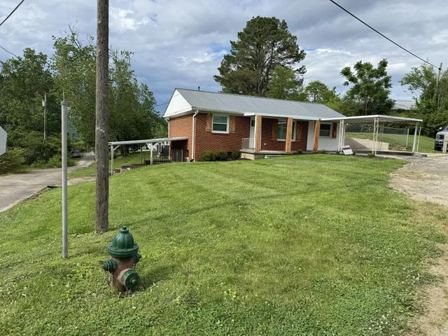 a backyard of a house with table and chairs