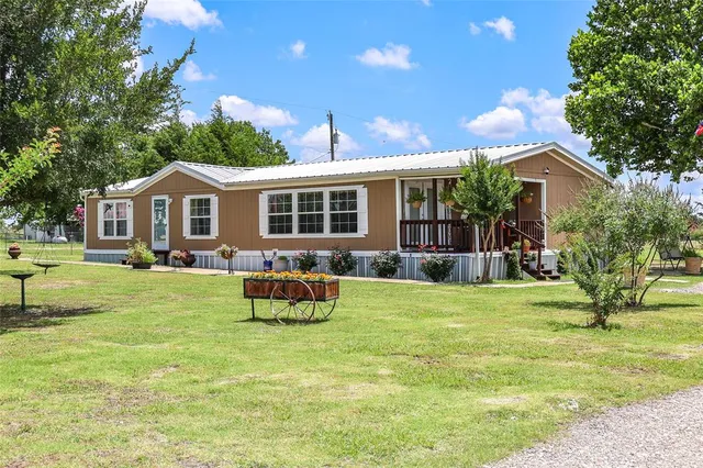 a front view of house with a garden and patio