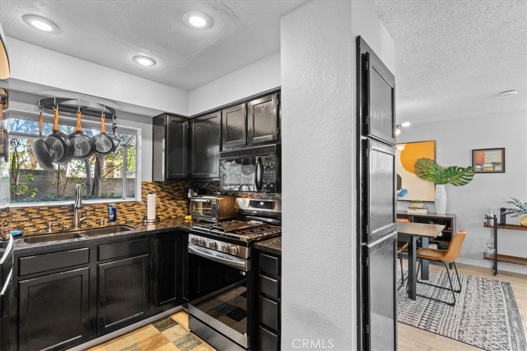 6433 Aleatico Place Rancho Cucamonga, CA 91737 - Photo 12 of 39 a kitchen with stainless steel appliances granite countertop a stove and cabinets