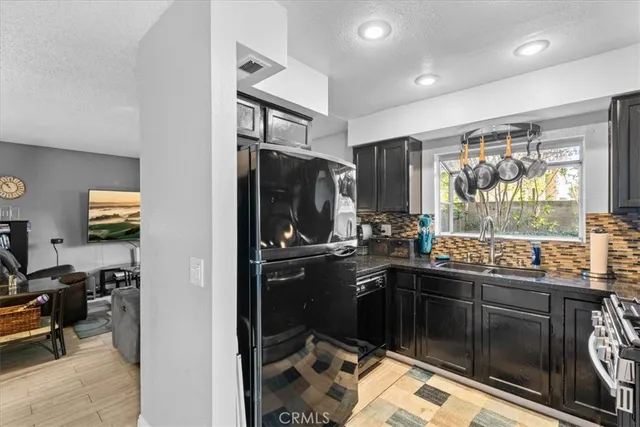 a kitchen with a sink stove and refrigerator