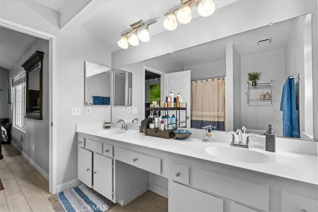 a bathroom with a double vanity sink and a mirror