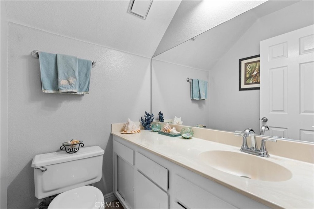 6433 Aleatico Place Rancho Cucamonga, CA 91737 - Photo 25 of 39 a bathroom with a toilet a sink and mirror