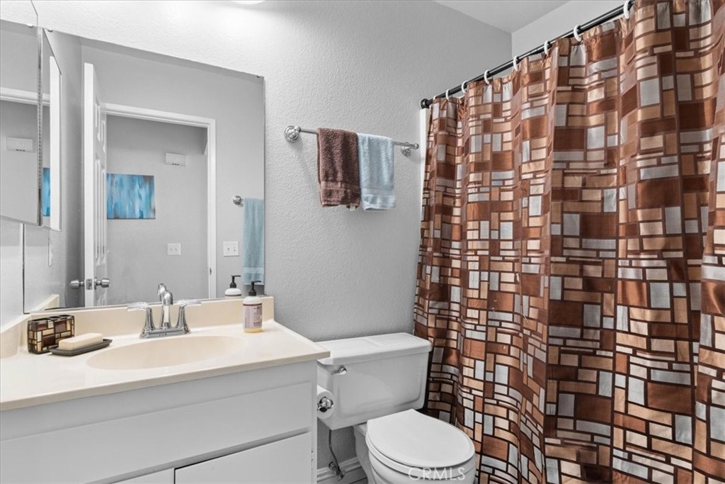 6433 Aleatico Place Rancho Cucamonga, CA 91737 - Photo 26 of 39 a bathroom with a sink toilet and shower