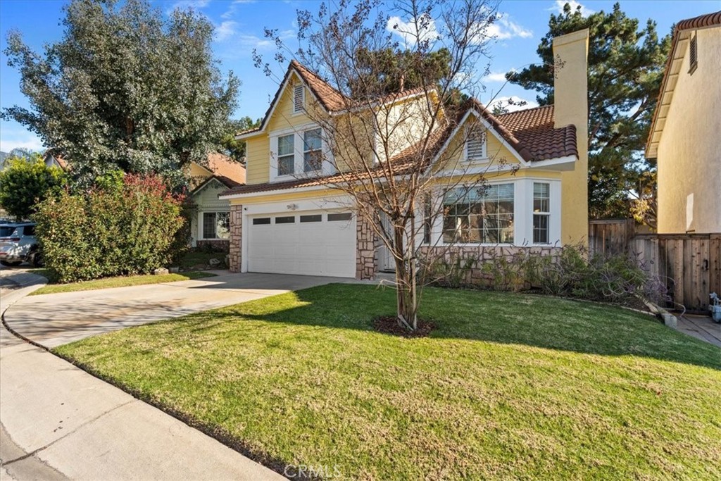 6433 Aleatico Place Rancho Cucamonga, CA 91737 - Photo 4 of 39 a front view of a house with a yard and trees