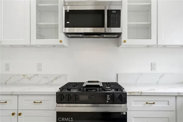 a kitchen with a stove and a microwave