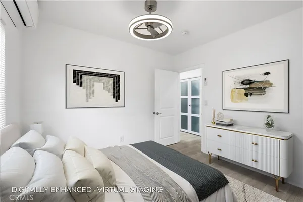a bedroom with a bed and a chandelier