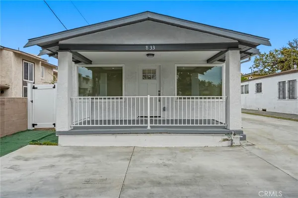 a front view of a house with a fence