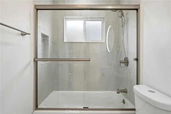 a bathroom with a shower and a toilet