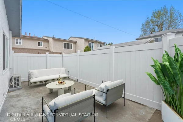 a view of a patio with couches and a potted plant on a table