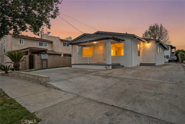 a view of a house with a yard and a garage