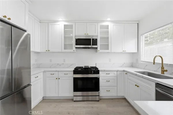 a kitchen with a sink stove and microwave