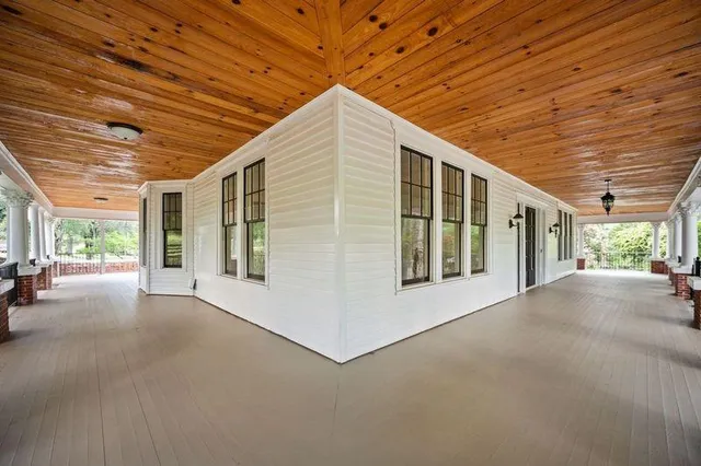 a view of a livingroom with wooden floor and a ceiling fan