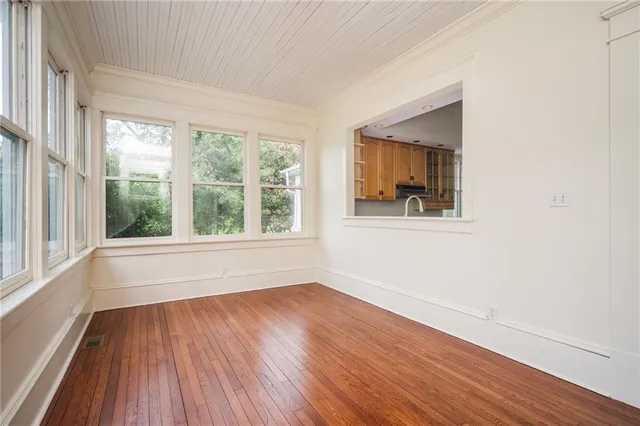 a view of empty room with wooden floor and fireplace