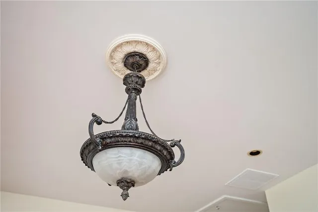an empty room with wooden floor fireplace and windows