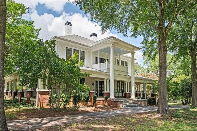 a view of a porch with wooden floor and outdoor seating