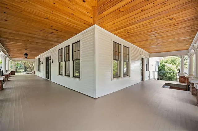 a view of a hallway with wooden floor and stairs