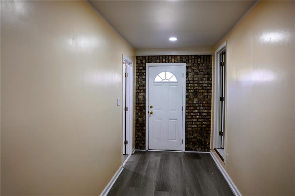 4296 Linda Lane Southwest Lilburn, GA 30047 - Photo 12 of 29 an empty room with wooden floor and windows