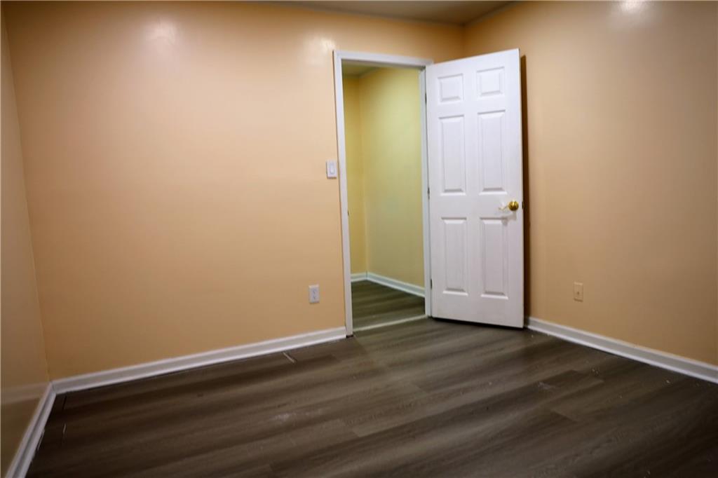 4296 Linda Lane Southwest Lilburn, GA 30047 - Photo 14 of 29 an empty room with wooden floor and closet