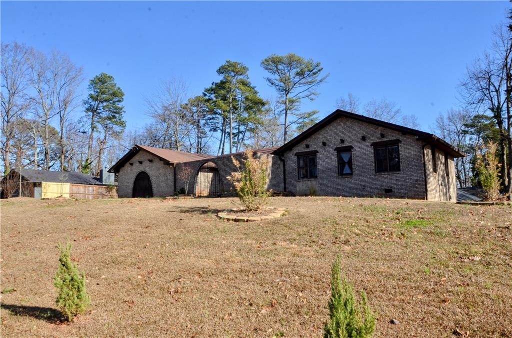 4296 Linda Lane Southwest Lilburn, GA 30047 - Photo 2 of 29 a wooden bench sitting in front of a house