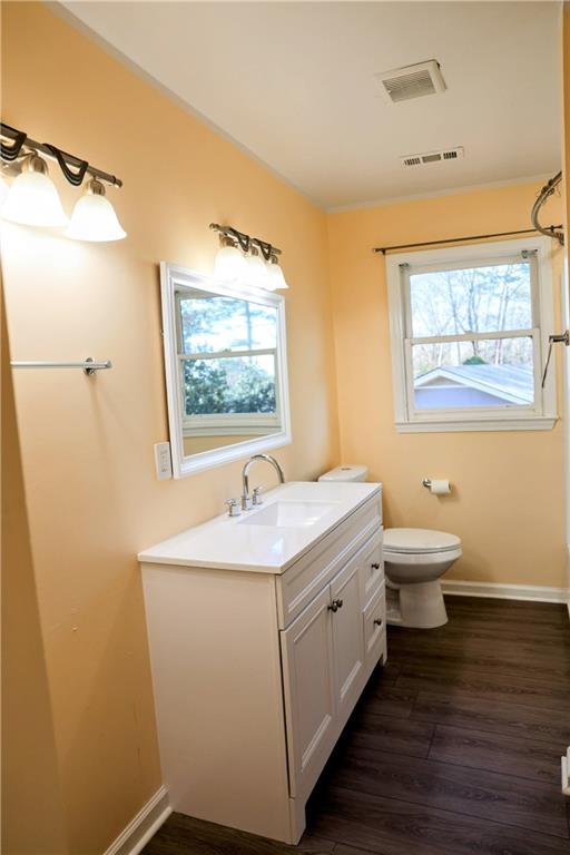 4296 Linda Lane Southwest Lilburn, GA 30047 - Photo 23 of 29 a bathroom with a double vanity sink toilet mirror and bathtub