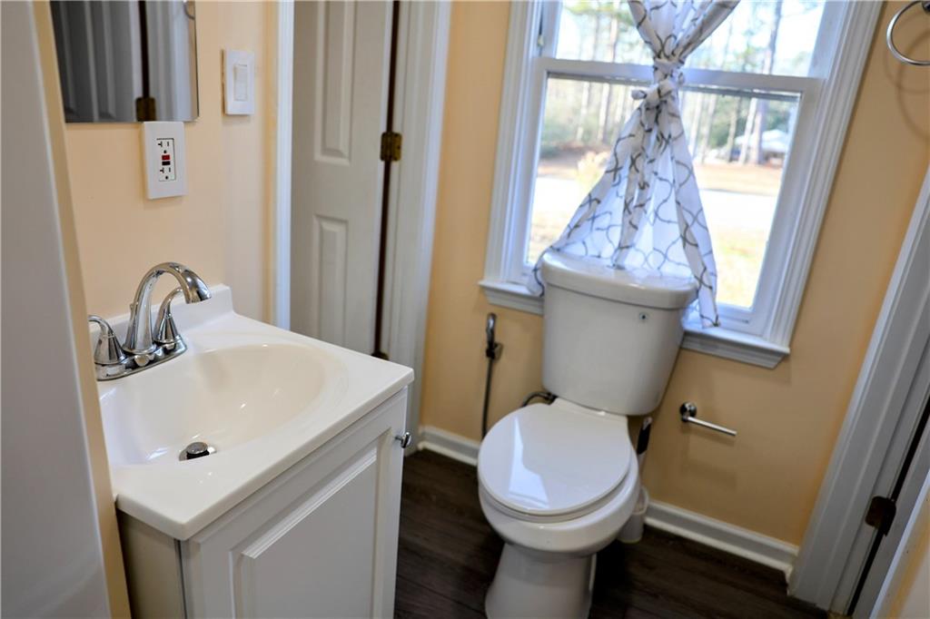 4296 Linda Lane Southwest Lilburn, GA 30047 - Photo 25 of 29 a bathroom with a sink and a toilet