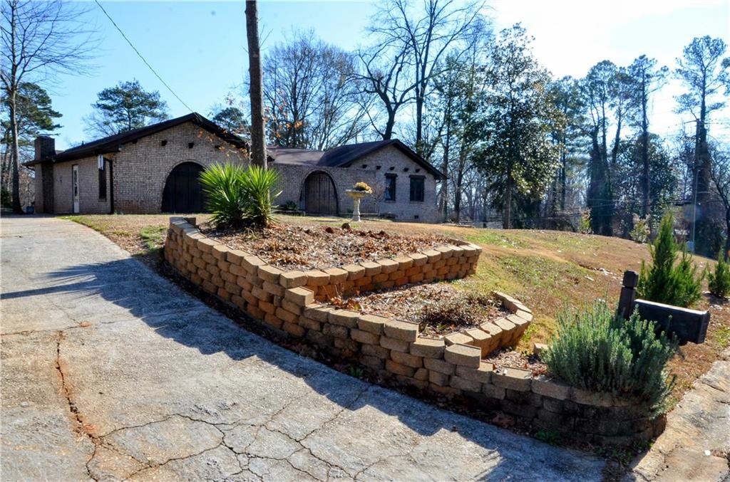 4296 Linda Lane Southwest Lilburn, GA 30047 - Photo 5 of 29 a view of a house with backyard and trees