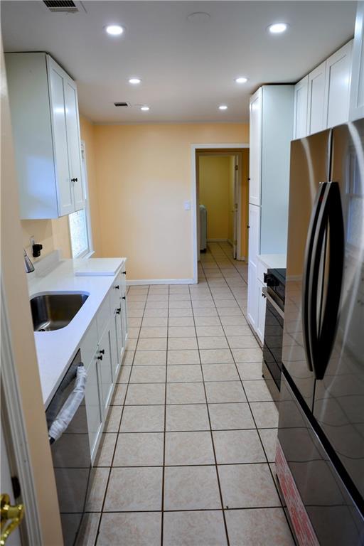 4296 Linda Lane Southwest Lilburn, GA 30047 - Photo 8 of 29 a kitchen with a sink a refrigerator and a stove