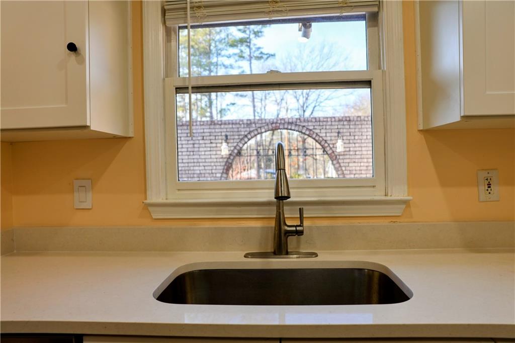 4296 Linda Lane Southwest Lilburn, GA 30047 - Photo 9 of 29 a bathroom with a sink a vanity and a large window