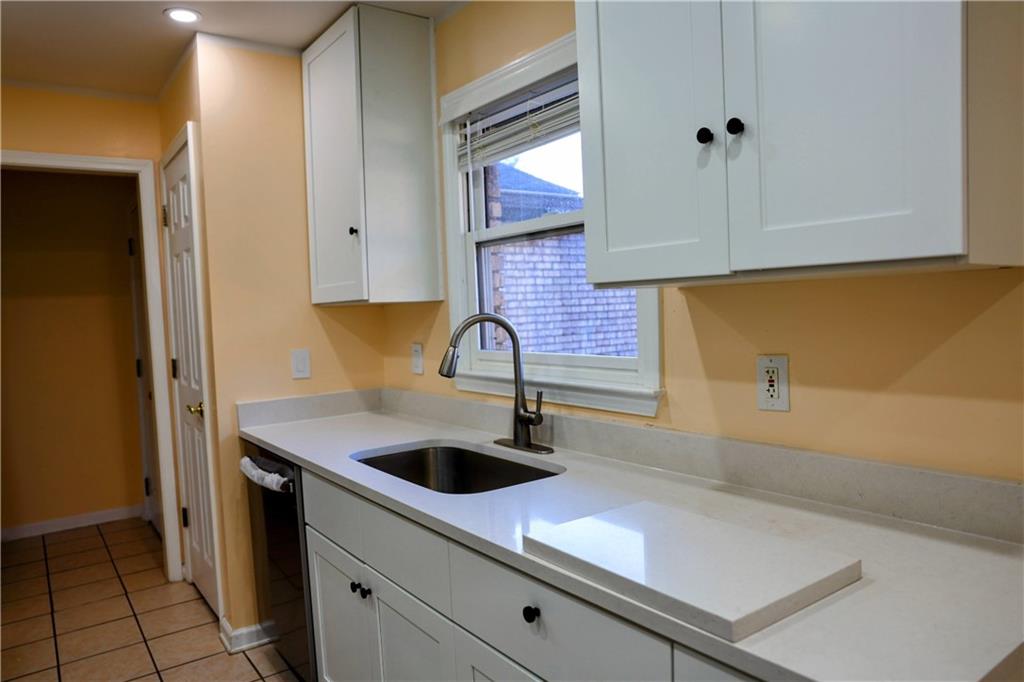 4296 Linda Lane Southwest Lilburn, GA 30047 - Photo 10 of 29 a kitchen with a sink and cabinets