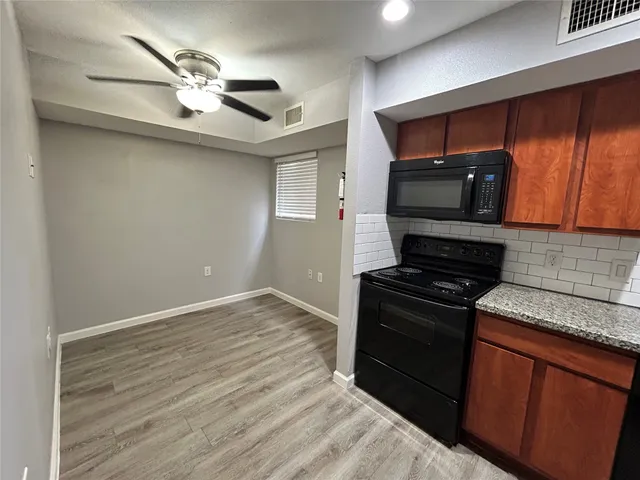 a kitchen with stainless steel appliances granite countertop a stove and a microwave